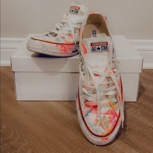 White Converse with neon paint splatter.